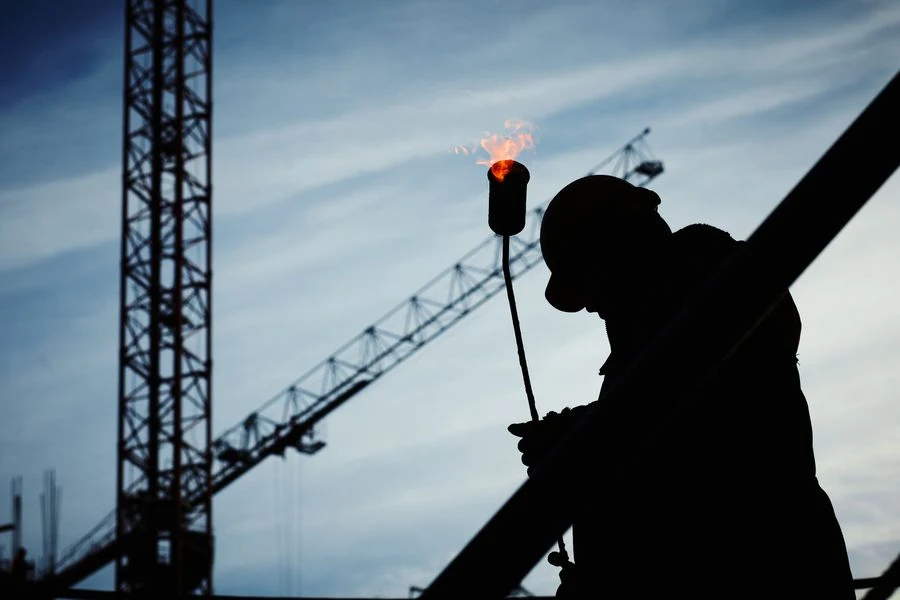 Tower crane silhouetted against the sky