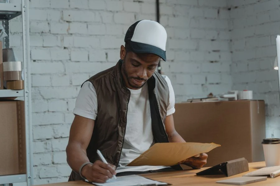 Site manager checking a job list on a clipboard
