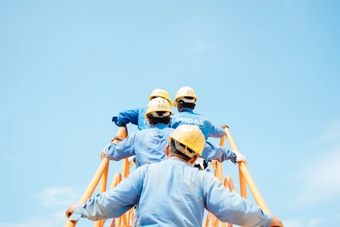 Construction crew in hard hats working together